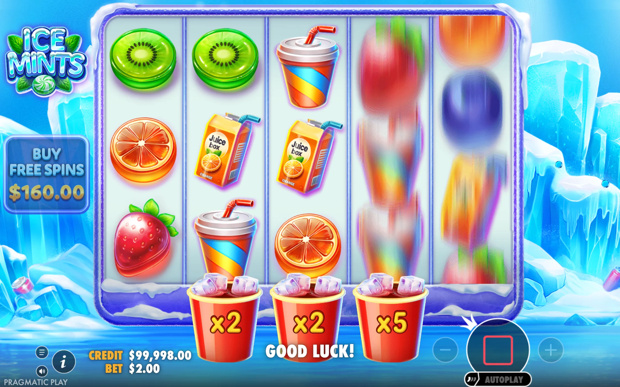 Colorful slot reels featuring fruit symbols like kiwi, strawberry, and orange slices, along with juice boxes and cups with straws, set against an icy blue frozen backdrop.