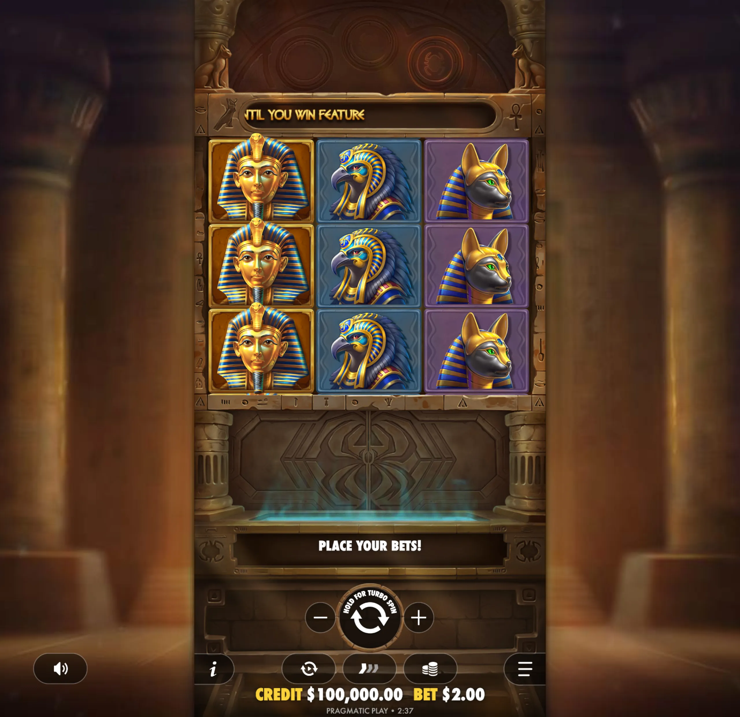 Slot game interface featuring Egyptian-themed symbols such as a pharaoh, falcon, and jackal heads, set against a backdrop of ancient pillars and hieroglyphics.