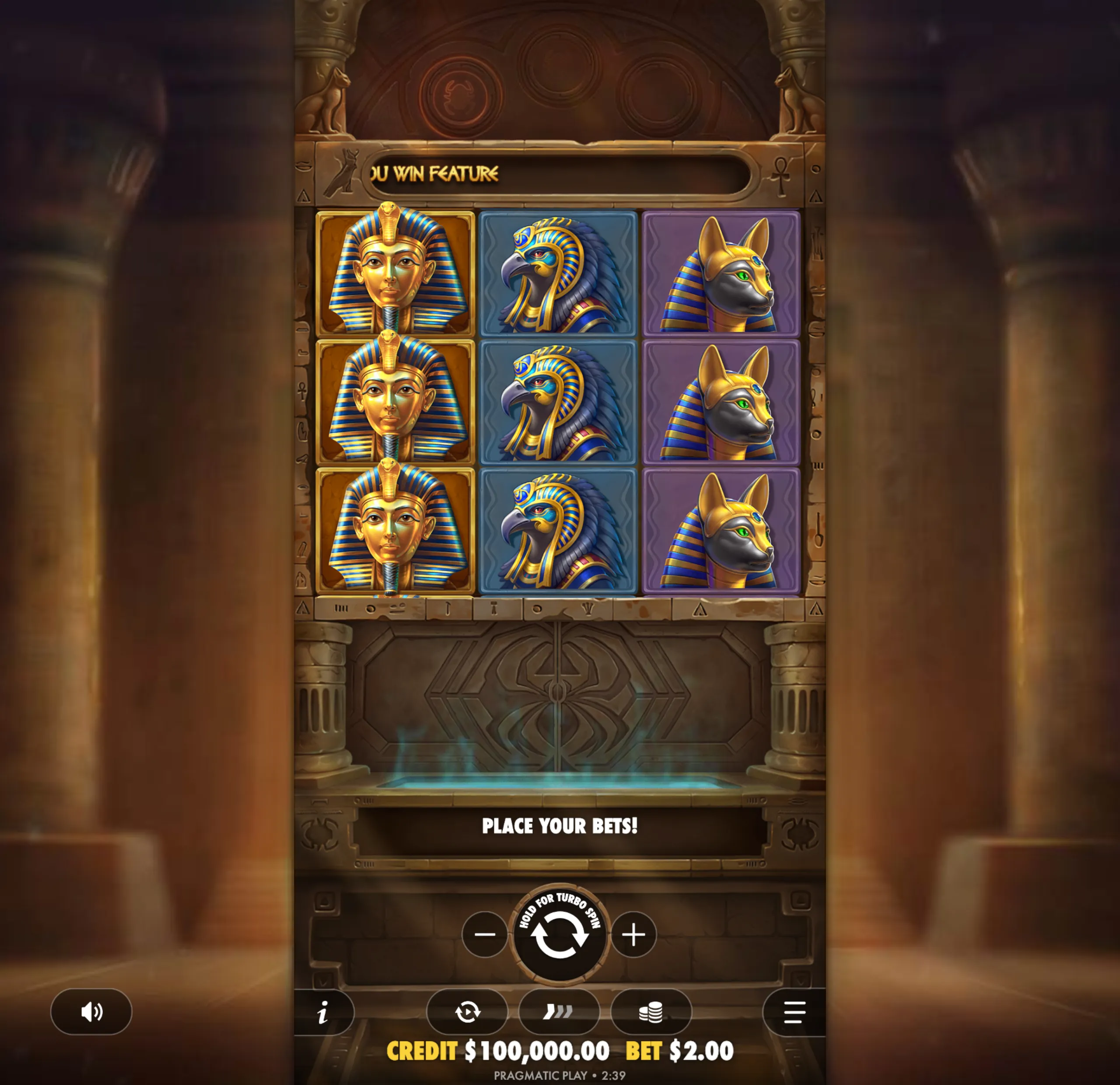 Slot game interface featuring Egyptian-themed symbols including a pharaoh, a falcon-headed god, and a jackal-headed god, set within an ancient temple backdrop.