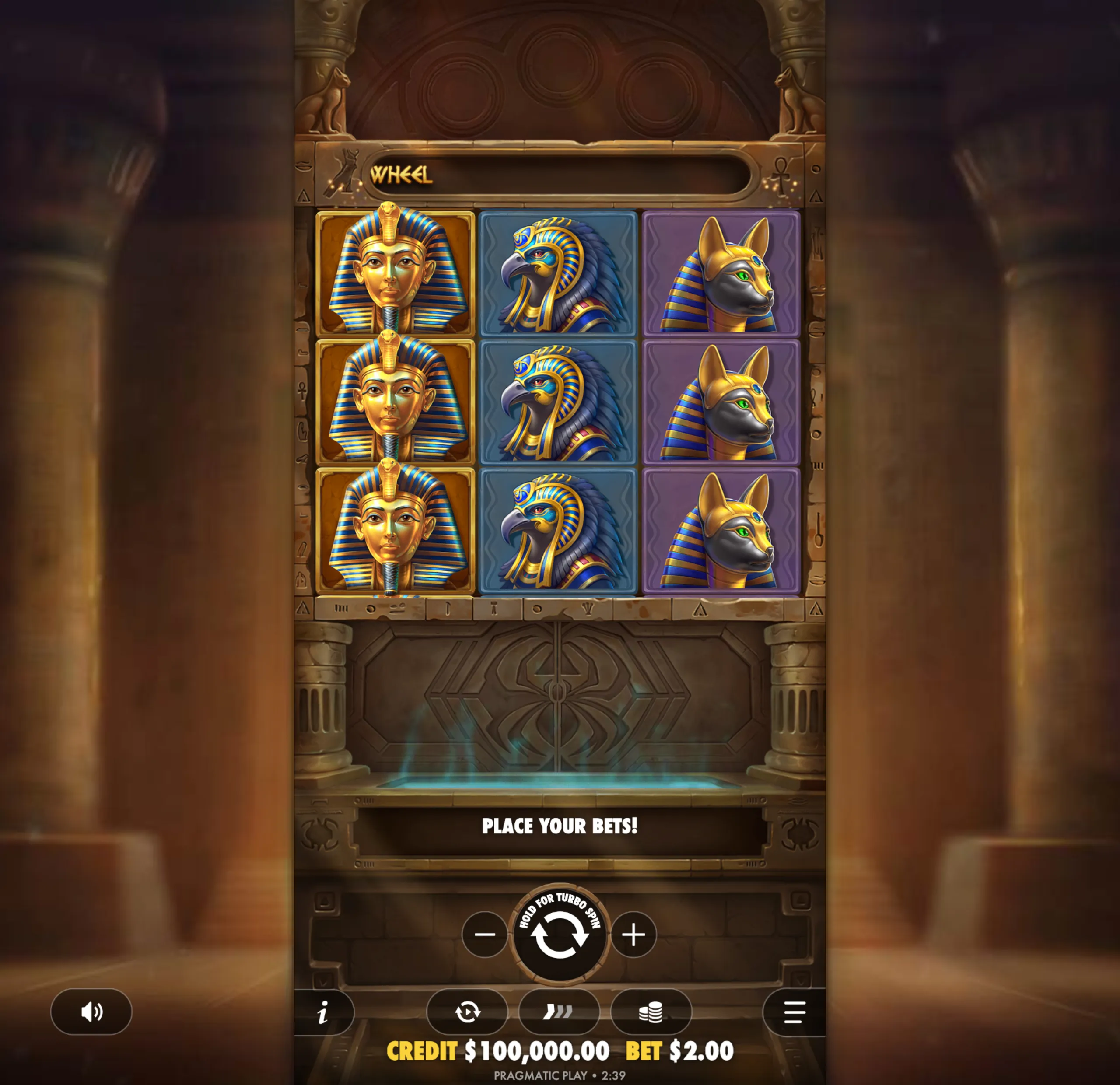 Ancient Egyptian-themed slot game reels featuring golden pharaoh masks, falcon-headed gods, and jackal-headed figures with hieroglyphic borders.