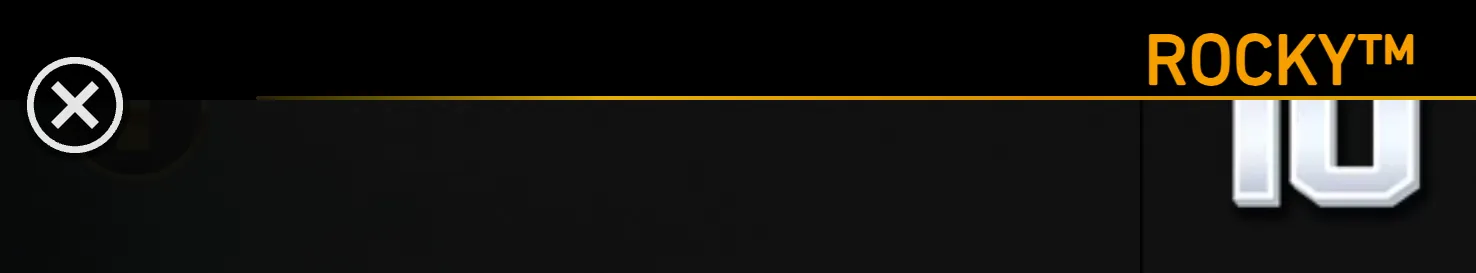A dark, mostly cropped slot interface header featuring the orange ROCKY™ logo, a circular close icon, and partial white lettering.