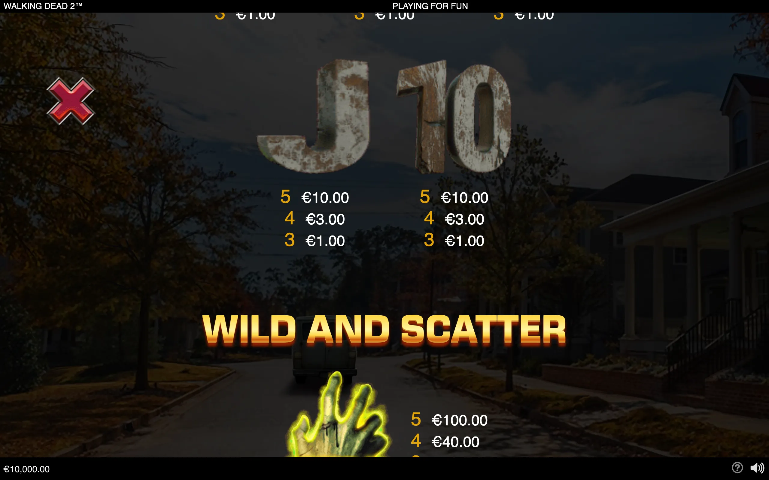 The Walking Dead 2 slot paytable displays a glowing zombie hand labeled Wild and Scatter against a dark, abandoned suburban street, with symbol payouts and a large distressed J symbol above.