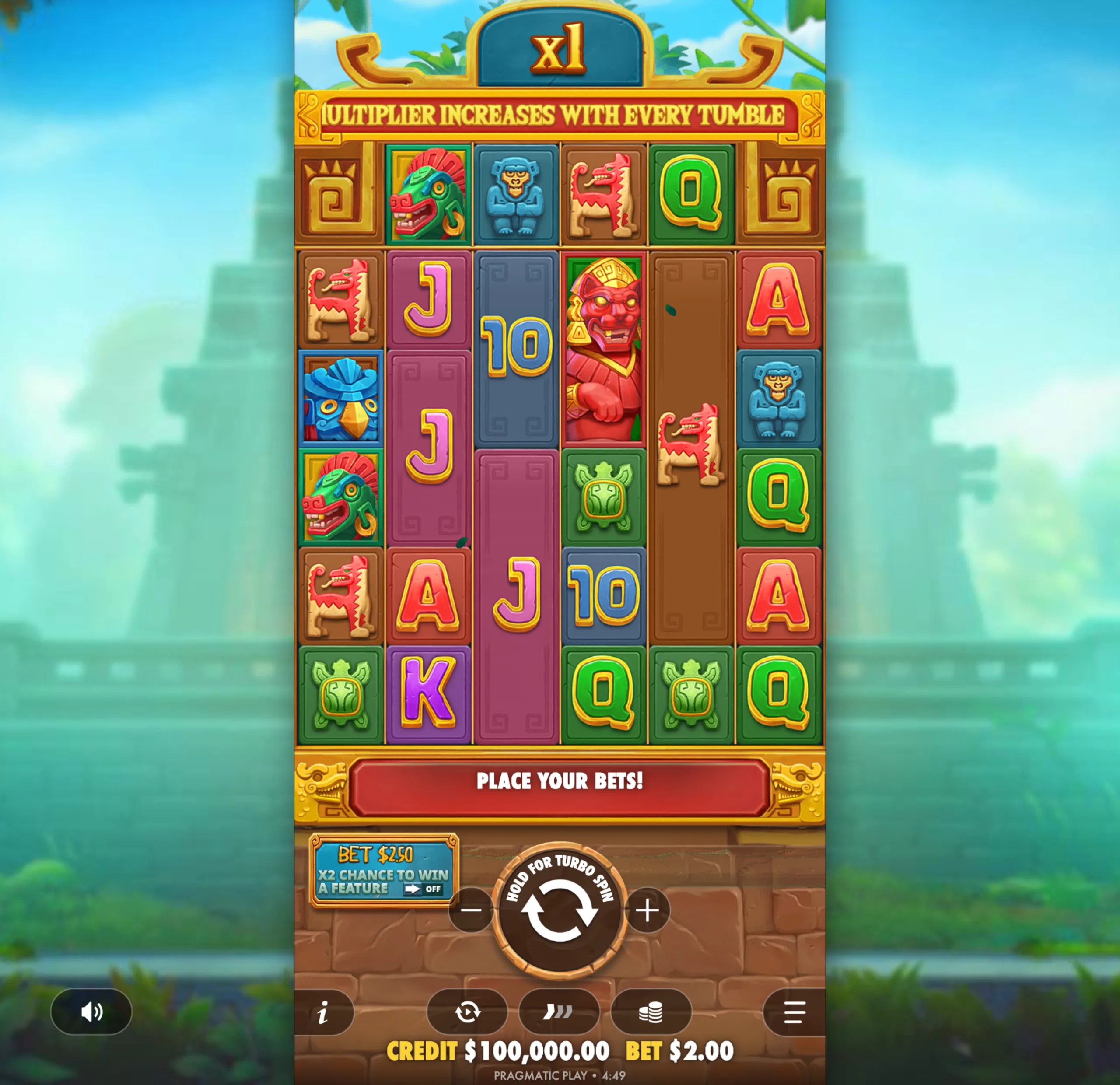 Colorful Aztec-themed slot reels featuring stone-carved animal symbols, traditional icons, and playing card letters with a multiplier indicator at the top.