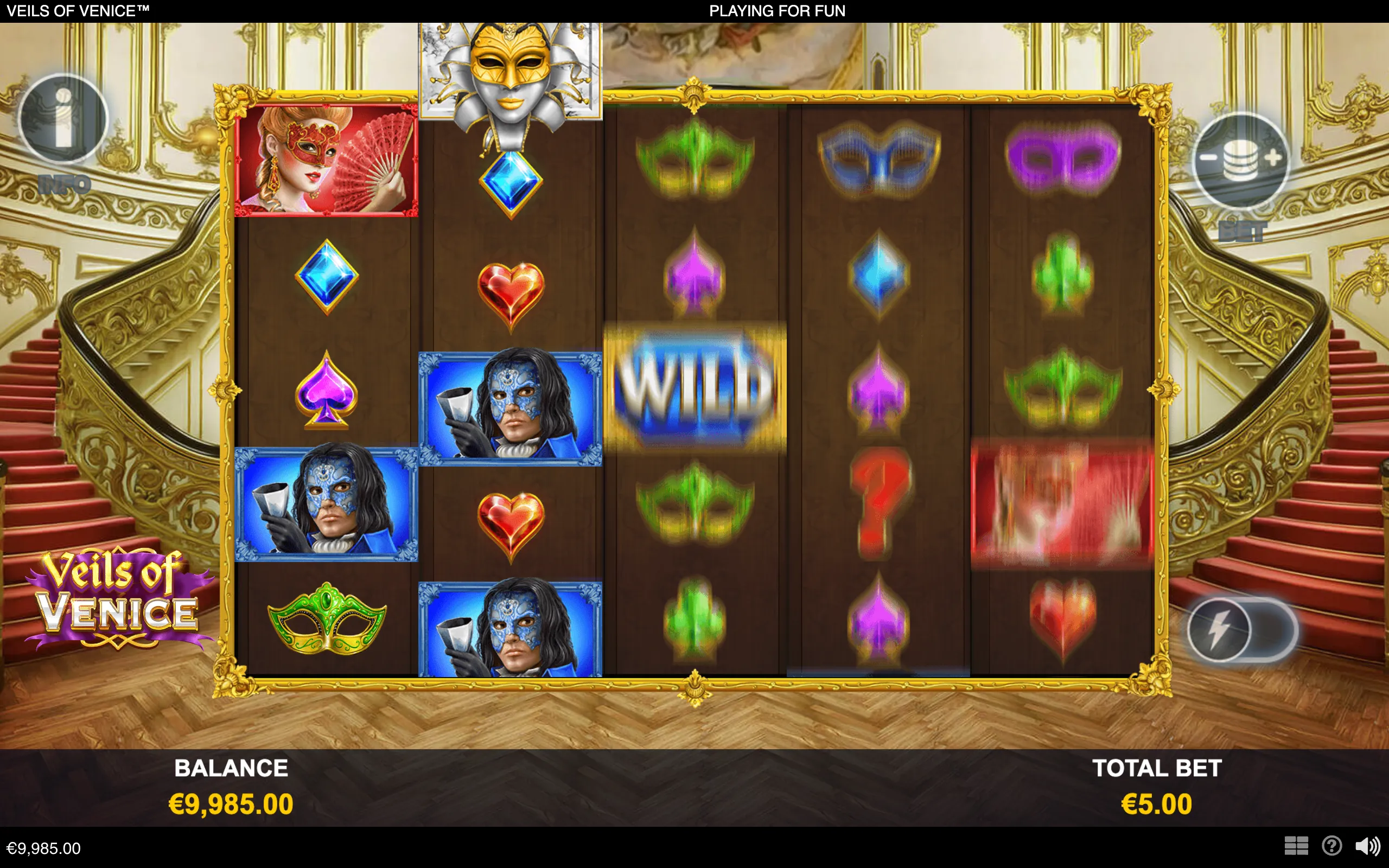 Veils of Venice slot reels display Venetian masks, masked characters, playing-card suit symbols, and a blue wild symbol inside an ornate gold frame, set against a grand palace staircase.