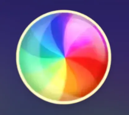 A glossy circular emblem divided into rainbow-colored segments, including blue, purple, pink, red, orange, yellow, green, and turquoise, against a dark purple backdrop.