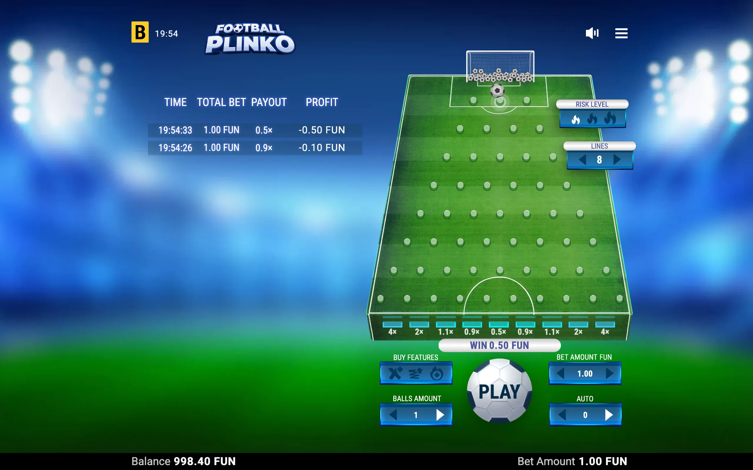 Football-themed Plinko game interface with a green pitch, goal, soccer ball, peg board, payout multipliers, and blue stadium lights.