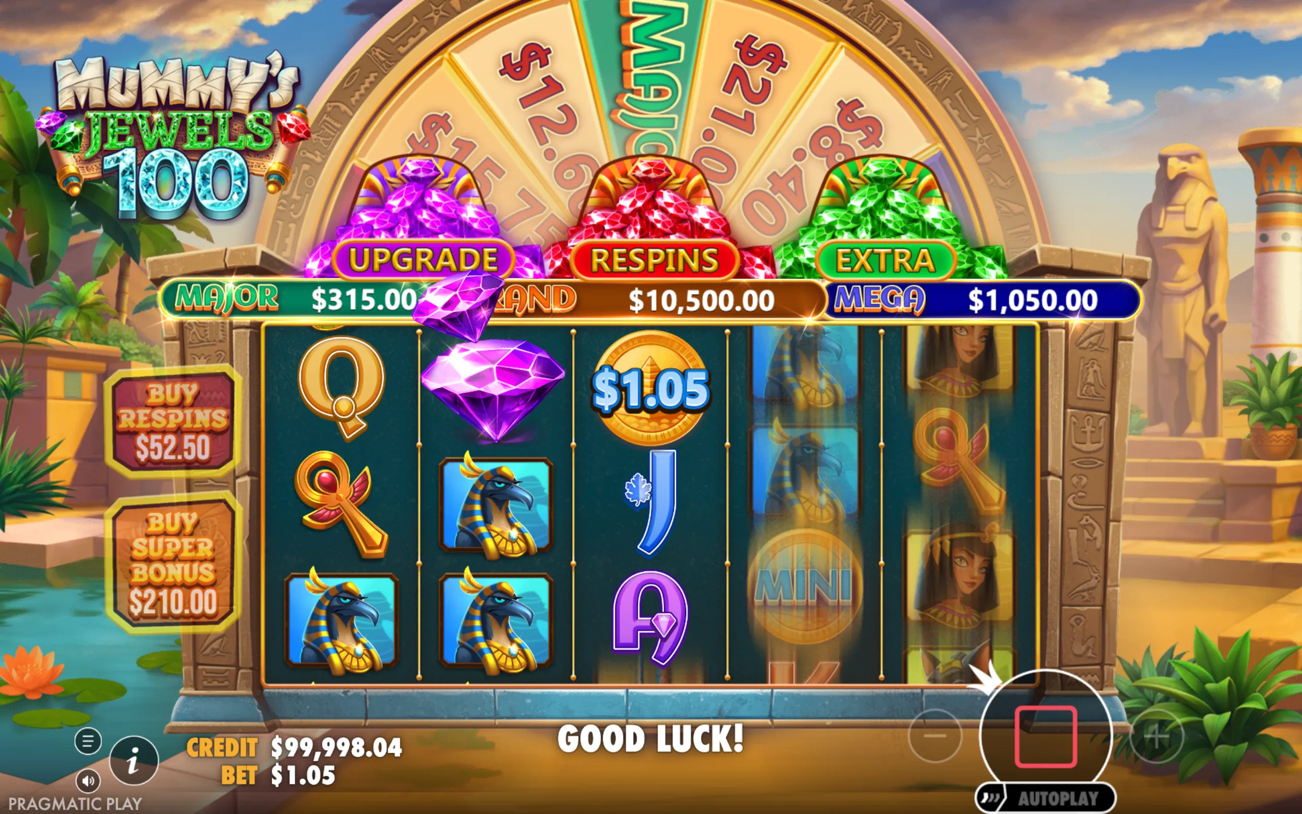 Mummy's Jewels 100 slot game interface featuring colorful gem symbols, Egyptian icons, and jackpot tiers with a desert temple backdrop.
