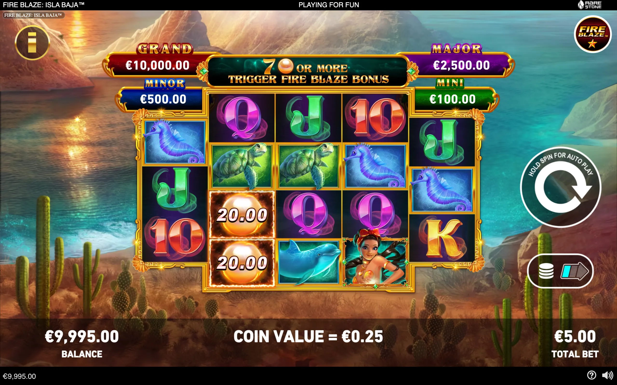 Fire Blaze Isla Baja slot reels display colorful seahorses, sea turtles, a dolphin, a mermaid, card symbols, cash-value orbs, and jackpot tiers over a tropical coastal landscape.