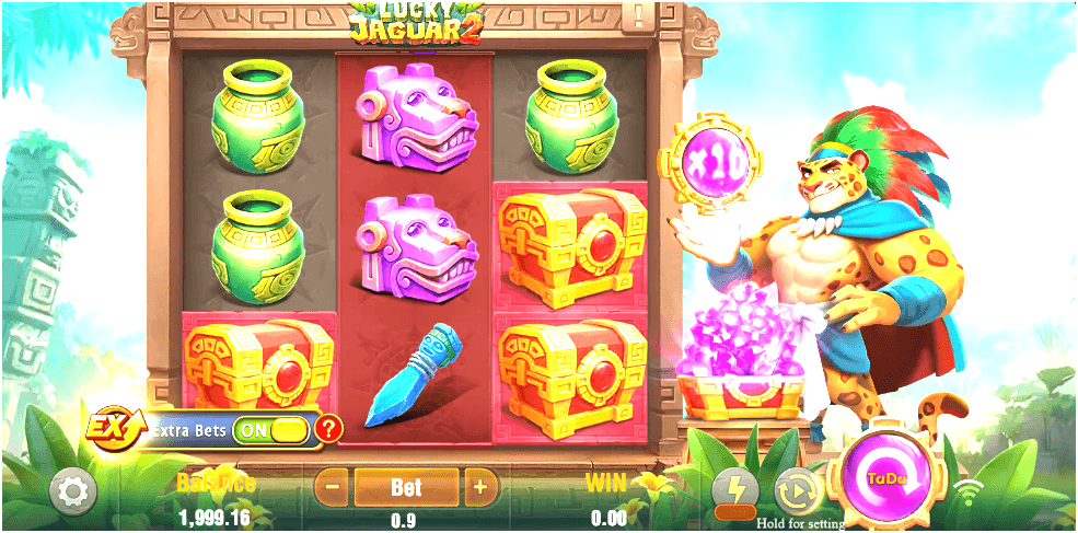 A colorful slot interface with three reels featuring jars, chests, and animal masks, alongside a jaguar warrior holding a glowing orb and a chest of gems; UI elements for bets, balance, and extra bet toggles appear at the bottom.