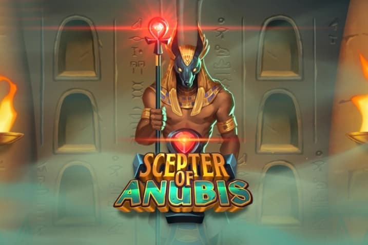 Anubis, the jackal-headed Egyptian god, stands in front of a stone wall with hieroglyphs, holding a glowing red scepter, flanked by torches, with the title "Scepter of Anubis" below.