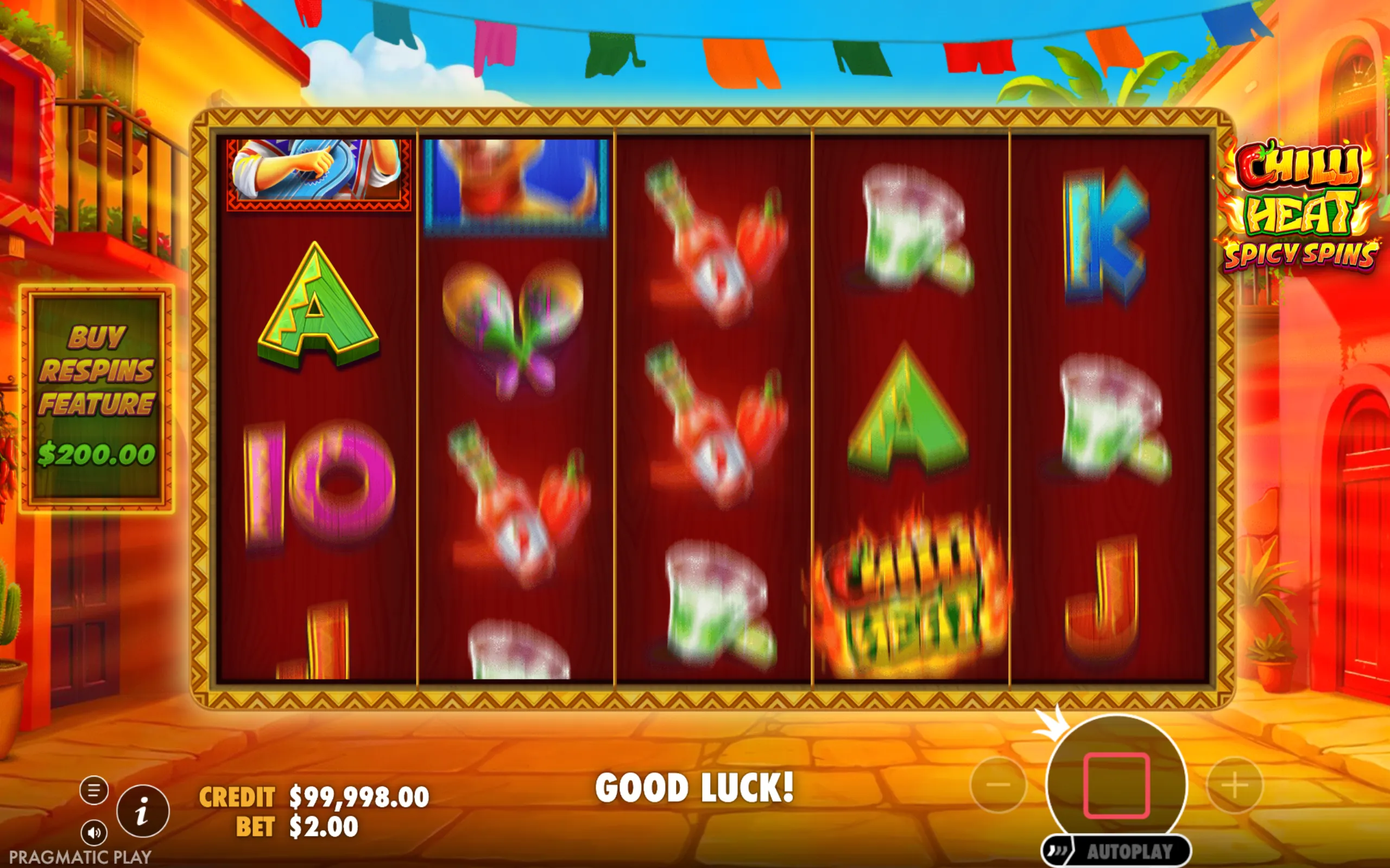 Chilli Heat Spicy Spins slot game with colorful symbols including chili peppers, maracas, and playing card icons, set against a bright Mexican street backdrop.