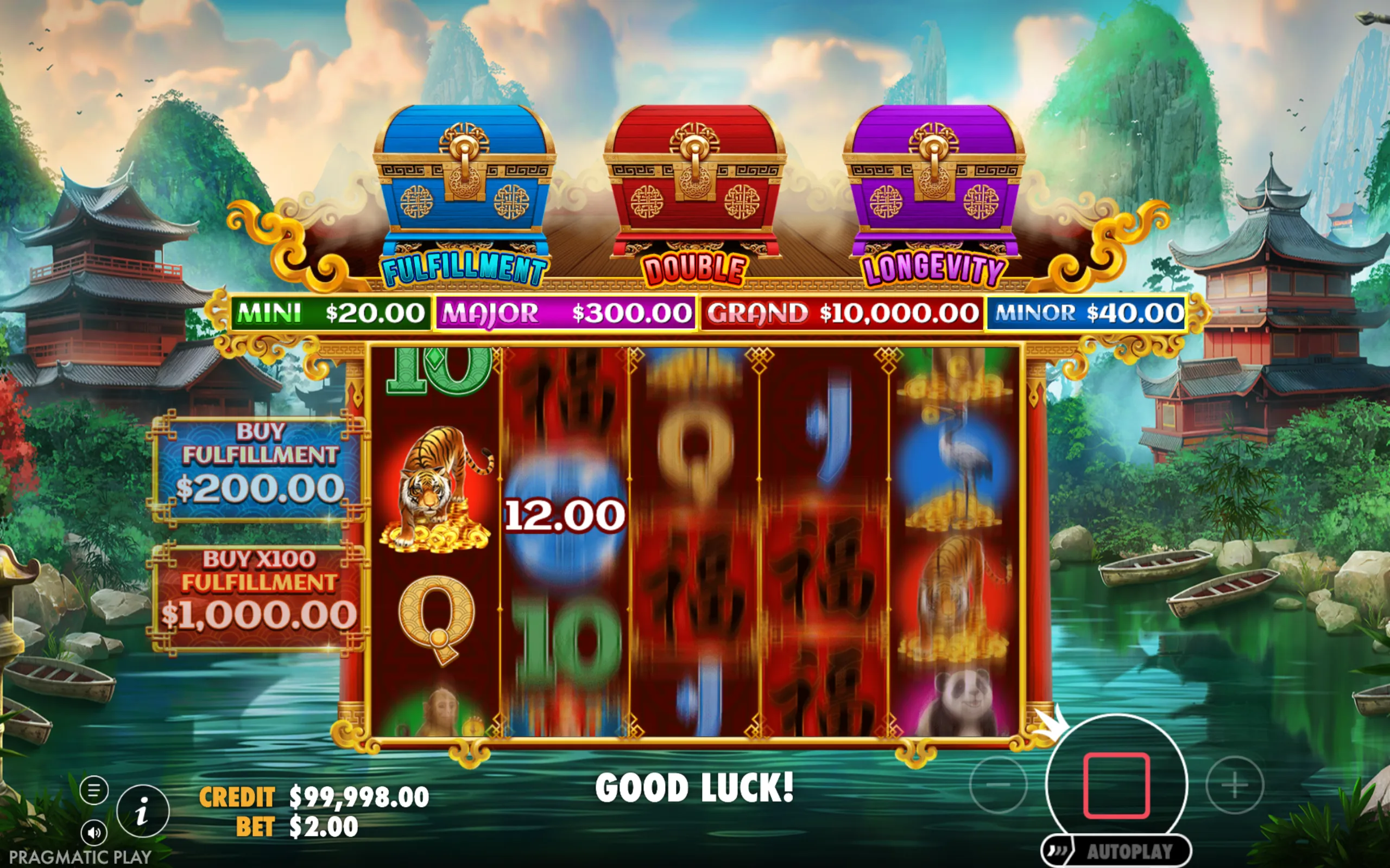 Asian-themed slot game interface featuring colorful treasure chests representing jackpot tiers with a serene mountain and river background.