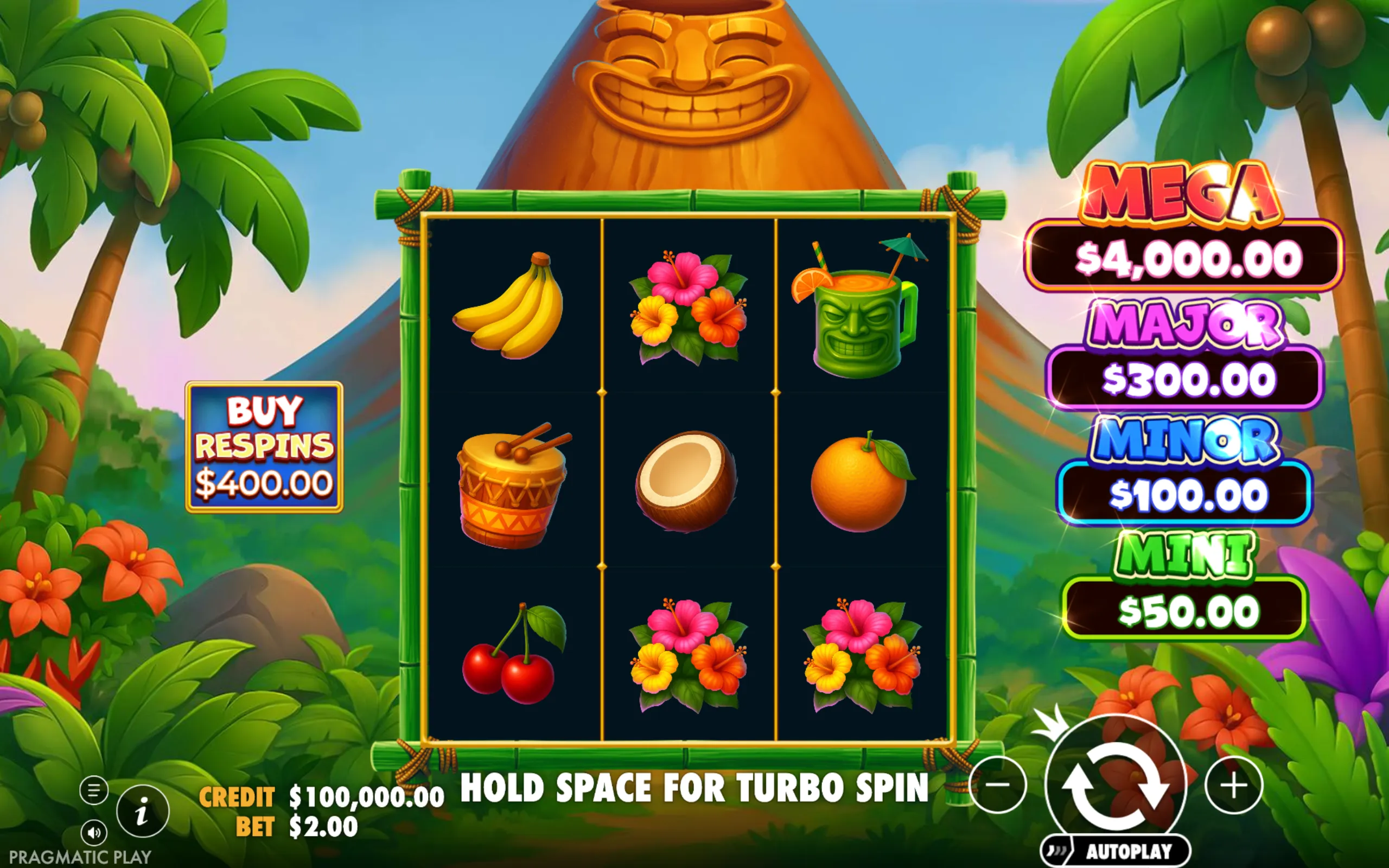 Tropical-themed slot game interface featuring colorful tiki symbols, fruits, and flowers with a volcano backdrop and jackpot tiers displayed.