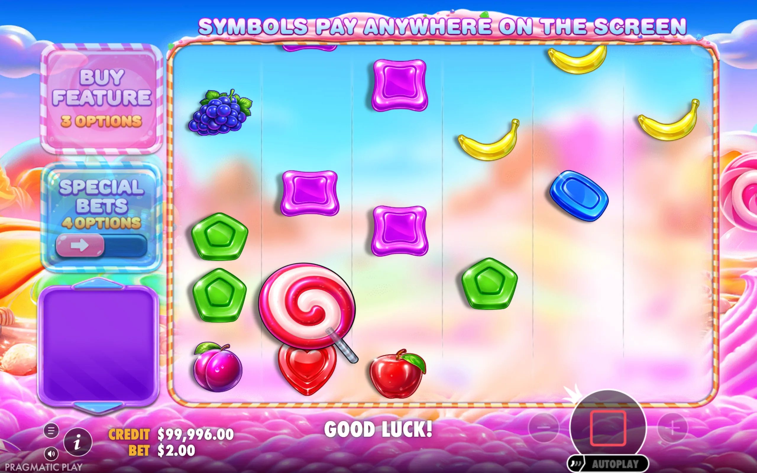 Candy-themed slot game reels with colorful fruit and candy symbols including grapes, bananas, lollipops, and hearts, set against a pastel sky background with options for buying features and special bets.