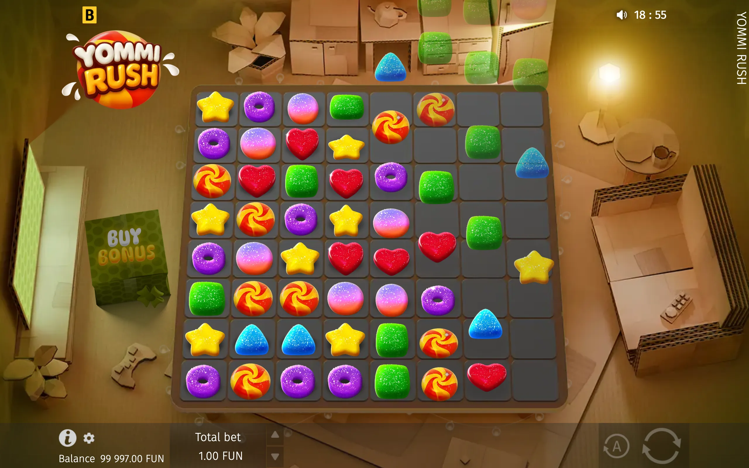 Yommi Rush slot interface with a large grid of colorful candy symbols, including stars, hearts, doughnuts, gumdrops, and swirl candies, set against a cardboard-themed backdrop.